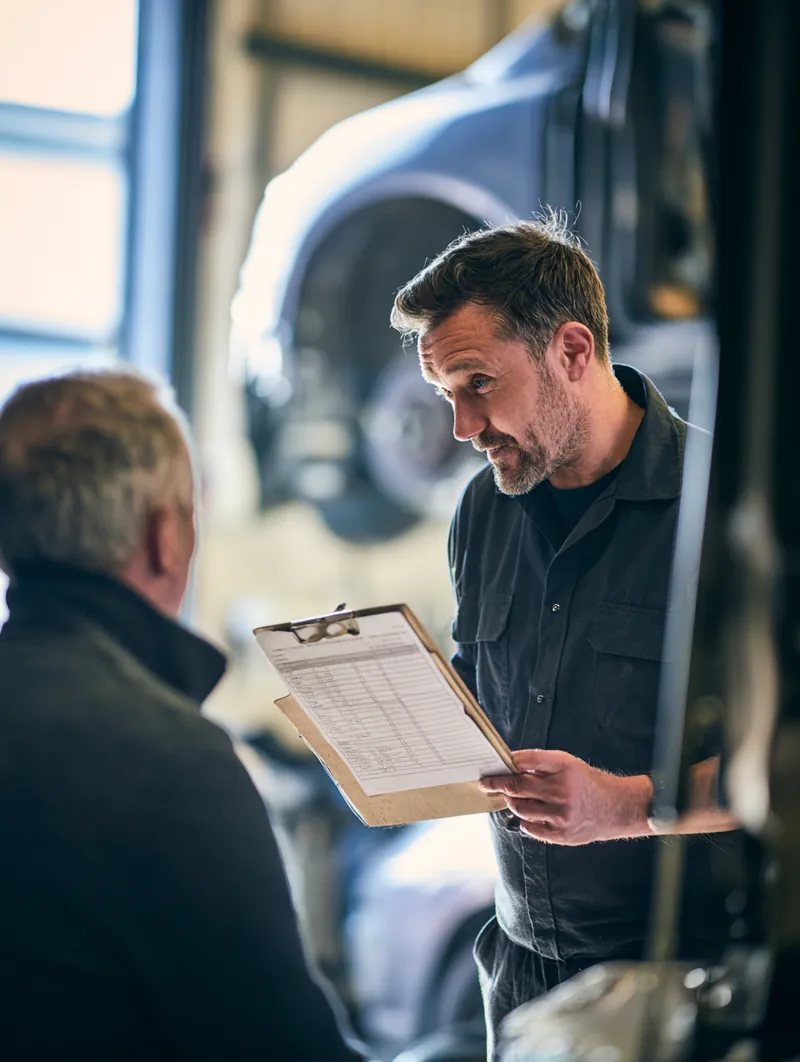 Reviewing each step of the auto repair loan process on paper